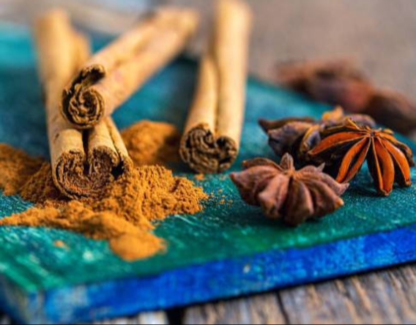 Cinnamon and star anise on wooden plank